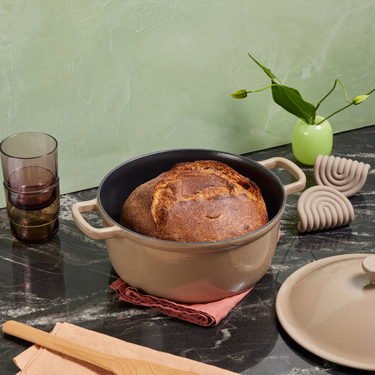 Beige Cast Iron Perfect Pot with bread and green background