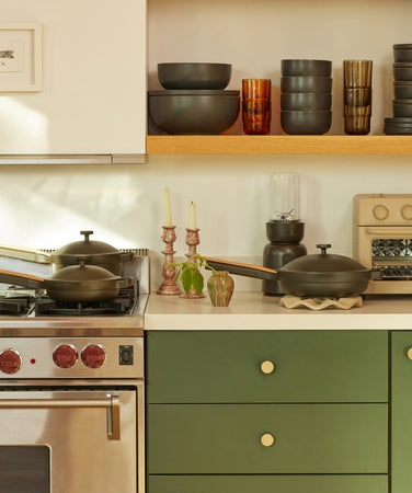 black dinnerware and cookware on counter and stove