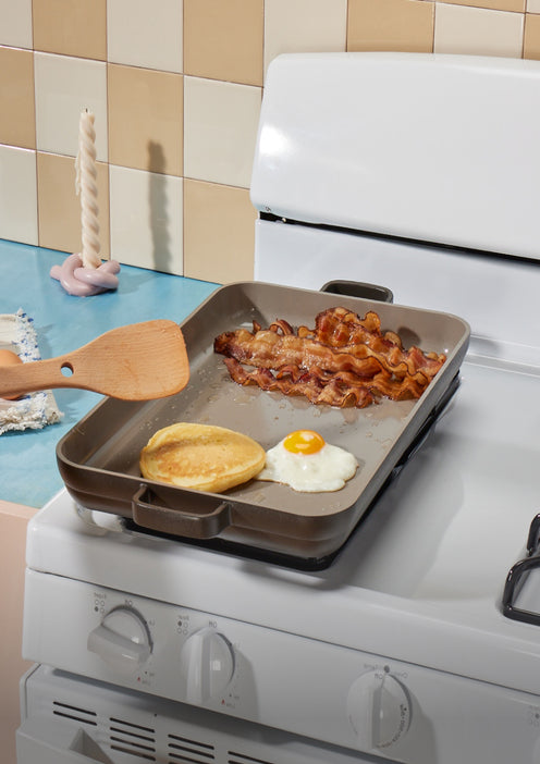 black griddle pan on stovetop with bacon