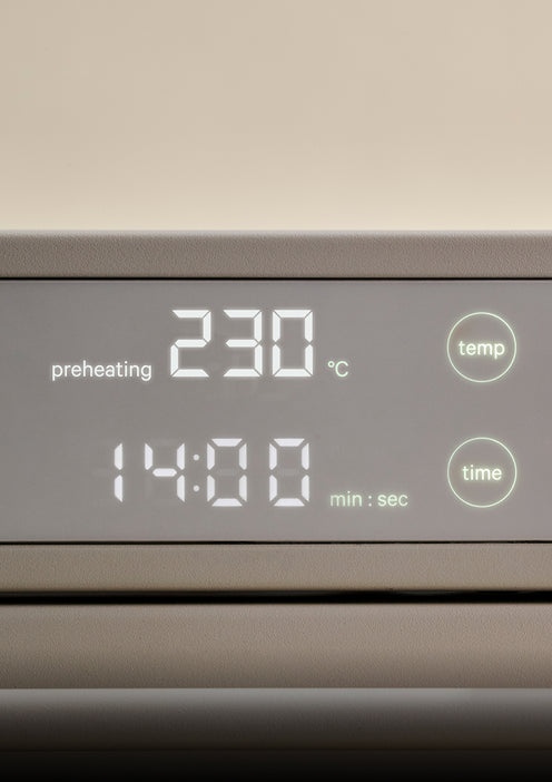 Digital display on an oven showing a preheating temperature of 230 degrees Celsius and a timer set to 14 minutes.