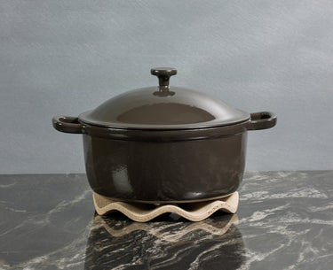 black cast iron perfect pot and wave trivet