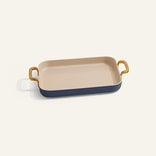 Rectangular ceramic dish with gold handles on a white background