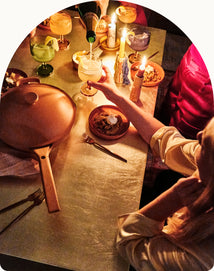 serving food and drinking on table with always pan and party coupes