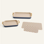 Two rectangular ceramic trays with gold accents and a matching checkered mat on a white background.