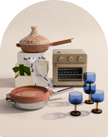 Set of miniature cookware and kitchen items on a neutral background
