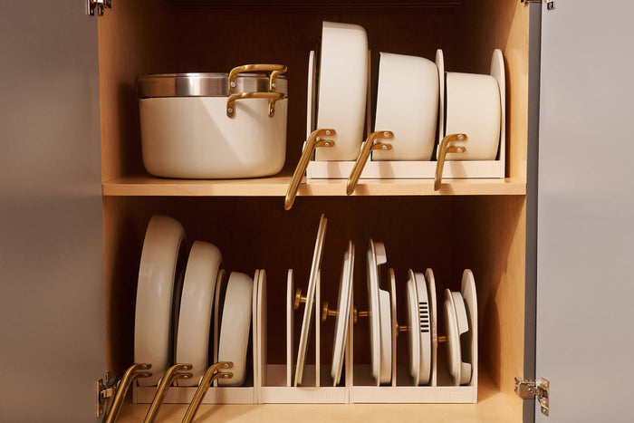 Cream cookware in a wooden cabinet 