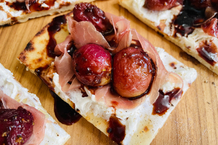 Naan Crostini with Roasted Grapes, Prosciutto, and Goat Cheese