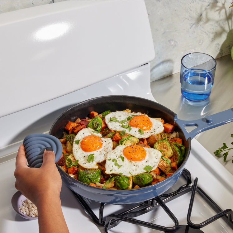 Blue Cast Iron Always Pan on stovetop with eggs and veggies