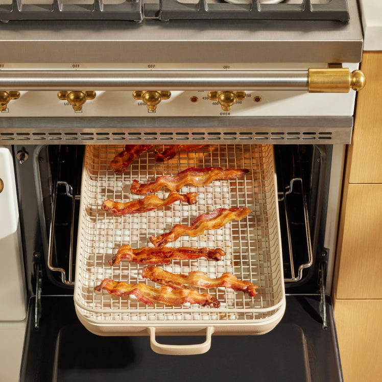 Bacon cooking on a beige Oven Rack