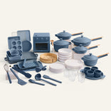 Collection of blue kitchenware including pots, pans, and utensils on a white background