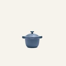 Centered against a plain, light background, the Petite Perfect Pot—a blue nonstick pot with dual handles—offers an ideal size for personal servings.
