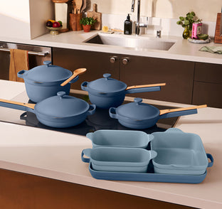 Blue pots, pans, and baking pans on a stovetop