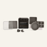 Collection of kitchen cookware including a toaster oven, pans, and a muffin tin on a white background