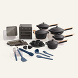 Set of kitchen cookware and utensils including pots, pans, and tools on a white background