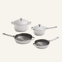 Titanium Pro Always Pan Trio 2.0 set including two light-colored lidded stainless steel pots and two frying pans of varying sizes.