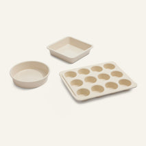 The Wonder Oven Pro Bakers Kit is a beige, PFAS-free nonstick set with a square pan, round cake pan, and 12-cup muffin pan shown on a white background.