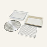The Wonder Oven Pro Chef’s Kit includes a metal mesh basket, baking pan, round tray, and cooling rack as practical cooking inserts.
