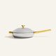Titanium Always Pan Pro 26 cm 2.0 silver-toned stainless steel frying pan with a lid and gold-colored handles.