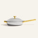 A silver Titanium Always Pan Pro 32 cm frying pan with a matching lid and gold-toned handles.