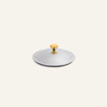Round, silver-toned Titanium Pro Lid (Mini) stainless steel lid with a small gold-toned knob handle.