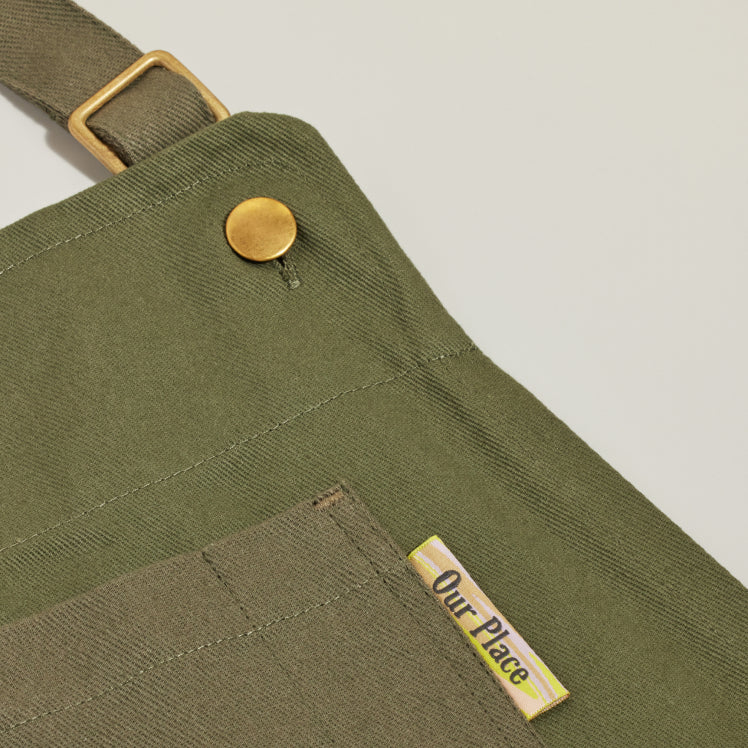 Close up of the top pocket on a green Home Cook Apron