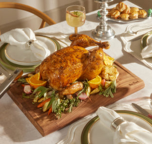 cooked turkey on walnut cutting board