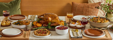 thanksgiving tablescape - dinner plates, salad plates, party coupes walnut cutting board, soup bowls, always pan on table
