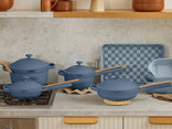 blue ultimate cookware set on stove and counter