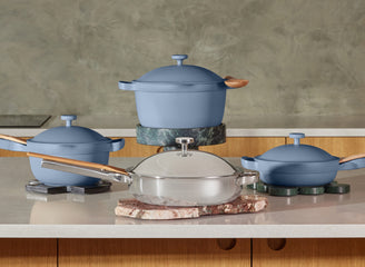 blue perfect pot and mini perfect pot on stove, titanium always pan pro and mini always pan on counter