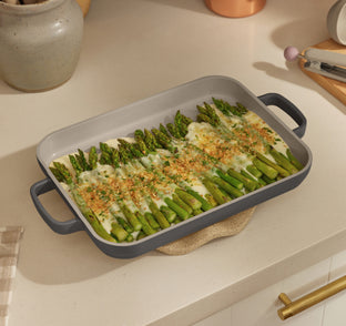 black mini griddle pan on counter with cooked asparagus 