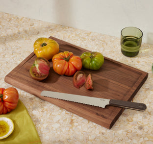 tomatoes on a walnut cutting board