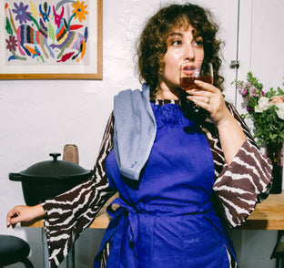 woman wearing blue hosting apron