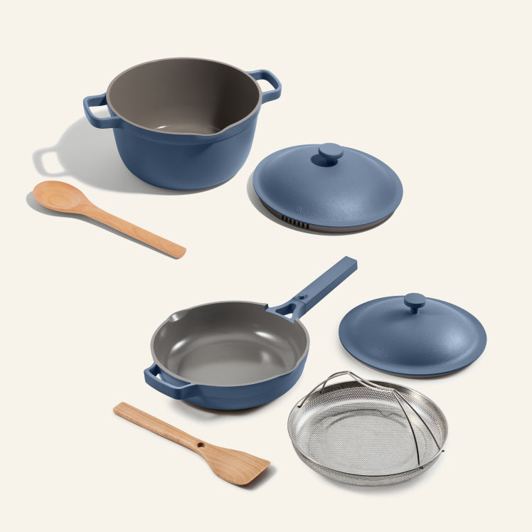 Set of blue cookware with gray interior on a white background