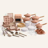 Collection of ceramic kitchenware including pots, pans, and utensils on a white background
