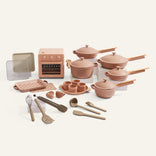 Set of pink kitchen utensils and appliances on a white background