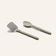 A Titanium Pro Utensil Set featuring a metal spatula and a solid-colored spoon side by side.