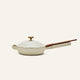 The Ceramic Nonstick Always Pan 20 cm, featuring a cream-colored finish, a matching lid, and a long brown handle, is displayed against a plain light background.