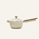 The Ceramic Nonstick Perfect Pot 2.5 L, shown in a cream hue with a lid and long handle against a plain light background, is ideal for preparing grains, soups, or sauces.