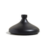 The CX - Tagine is a matte black, cone-shaped ceramic vase featuring a small circular opening at the top, displayed on a plain white background.